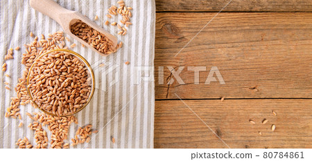 Wholegrain uncooked raw spelt farro in a bowl with napkin on the wooden table Wholegrain uncooked raw spelt farro in a bowl with napkin on the wooden table 80784861