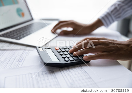 Close up of ethnic woman pay bills on laptop online Close up of ethnic woman pay bills on laptop online 80788319