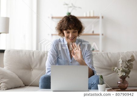 Happy young attractive woman starting video call conversation. Happy young attractive woman starting video call conversation. 80790942