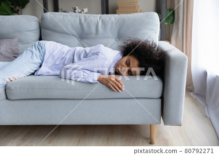 Exhausted biracial woman sleep on couch at home 80792271