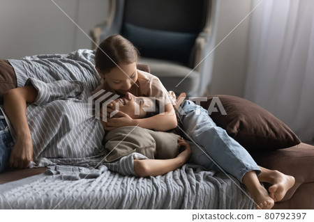Cute happy child hugging and cuddling mom Cute happy child hugging and cuddling mom 80792397