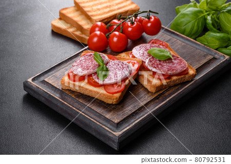 Spanish dried sausage salami on a dark concrete background 80792531