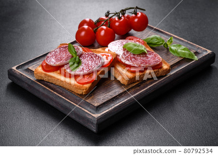 Spanish dried sausage salami on a dark concrete background 80792534