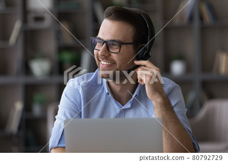 Young guy remote consultant in headset feel glad helping customers Young guy remote consultant in headset feel glad helping customers 80792729