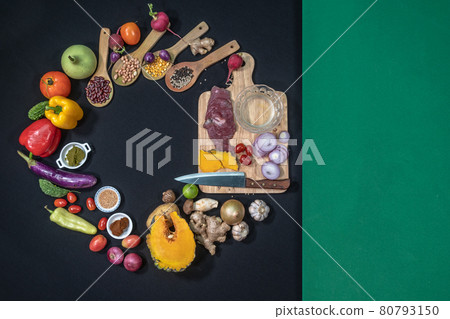 .top view Fresh food is placed on a black table with a green cloth on the side. 80793150