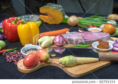 Assorted vegetables, spices and mushrooms are prepared for cooking. 80793154