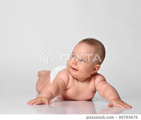 6 month old baby infant lies in one diaper on a 80793678