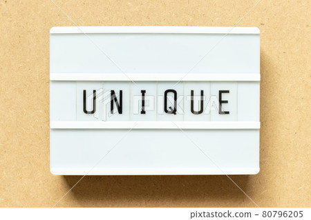 Lightbox with word unique on wood background 80796205