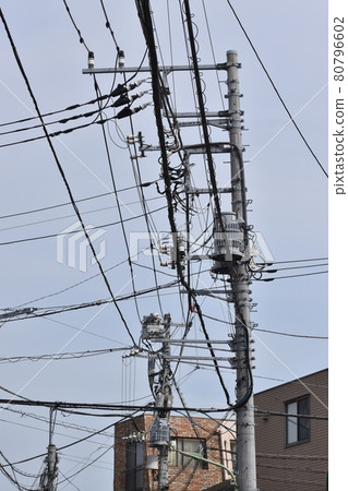 Various cables and wires and utility poles that support them Various cables and wires and utility poles that support them 80796602