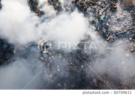 Garbage and fire burn in landfill cause of air pollution, environmental damage and global warming. 80799631