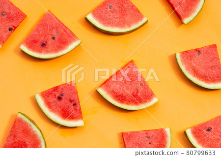 Watermelon slices on orange background. Watermelon slices on orange background. 80799633