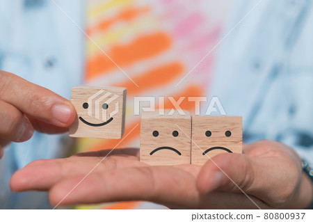 Smile face and cart icon on wood cube. Optimistic person or people feeling inside and service rating when shopping, satisfaction concept. Smile face and cart icon on wood cube. Optimistic person or people feeling inside and service rating when shopping, satisfaction concept. 80800937