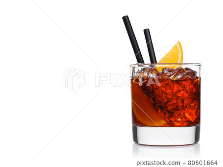 Negroni Cocktail in modern glass with ice cubes and orange slices with straw on white background Negroni Cocktail in modern glass with ice cubes and orange slices with straw on white background 80801664