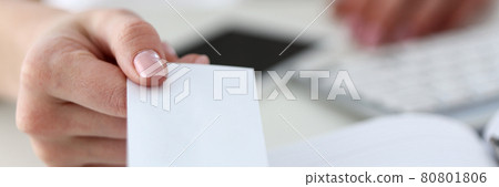 Female hand in suit give blank calling card to visitor closeup Female hand in suit give blank calling card to visitor closeup 80801806