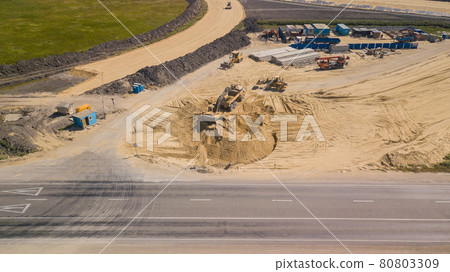 Excavator Is Loading Ground Into Truck On Construction Of Traffic Interchange Excavator Is Loading Ground Into Truck On Construction Of Traffic Interchange 80803309