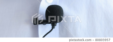 Lapel microphone is worn on men blue shirt 80803957