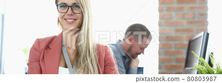 Portrait of smiling businesswoman with glasses in office 80803987