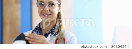 Portrait of smiling research scientist with microscope Portrait of smiling research scientist with microscope 80804354
