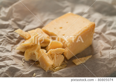 pieces of aged hard cheese on paper pieces of aged hard cheese on paper 80805074