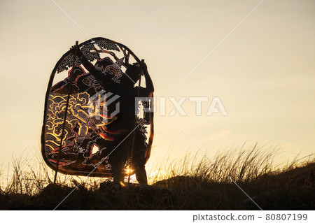 man hold Thai shadow angel puppet at sunset 80807199