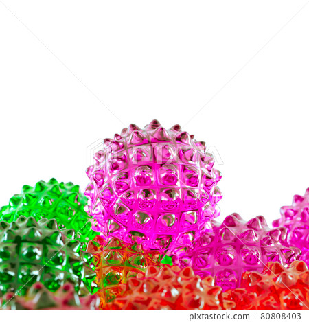 A purple glass ball with spikes rests on other colored balls similar to the covid virus. 3d rendering 80808403