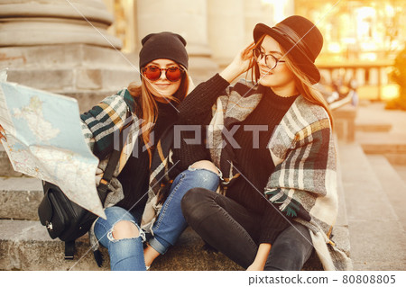 two young girls walk around the city in the autumn city and park 80808805