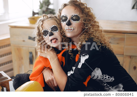 Mother with daughter in a halloween costume and makeup Mother with daughter in a halloween costume and makeup 80808841