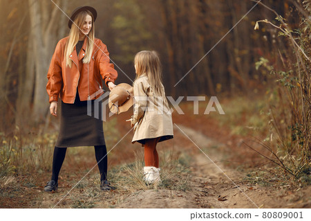 Cute and stylish family in a autumn park Cute and stylish family in a autumn park 80809001