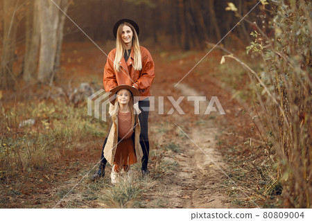 Cute and stylish family in a autumn park Cute and stylish family in a autumn park 80809004
