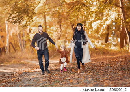 Family with little daughter in a autumn park Family with little daughter in a autumn park 80809042