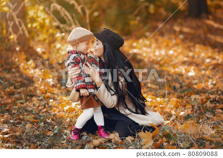 Cute and stylish family in a autumn park 80809088