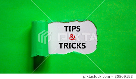Tips and tricks symbol. Words 'Tips and tricks' appearing behind torn green paper. Beautiful green background. Business, Tips and tricks concept. Copy space. Tips and tricks symbol. Words 'Tips and tricks' appearing behind torn green paper. Beautiful green background. Business, Tips and tricks concept. Copy space. 80809198