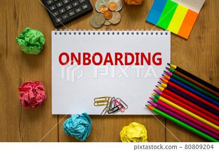 Onboarding symbol. White note with a word 'onboarding' on beautiful wooden table, colored paper, colored pencils, paper clips, coins and calculator. Business and onboarding concept. Onboarding symbol. White note with a word 'onboarding' on beautiful wooden table, colored paper, colored pencils, paper clips, coins and calculator. Business and onboarding concept. 80809204