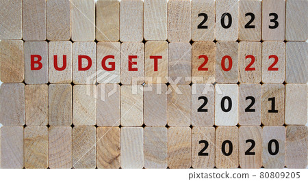 Business concept of budget planning 2022. Wooden cubes with the inscription 'BUDGET 2022' and numbers 2020, 2021, 2023. Beautiful wooden background, copy space. Business, 2022 budget concept. Business concept of budget planning 2022. Wooden cubes with the inscription 'BUDGET 2022' and numbers 2020, 2021, 2023. Beautiful wooden background, copy space. Business, 2022 budget concept. 80809205