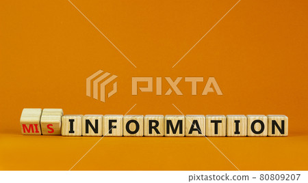 Information or misinformation symbol. Turned cubes and changed the word misinformation to information. Orange background, copy space. Business and information or misinformation concept. Information or misinformation symbol. Turned cubes and changed the word misinformation to information. Orange background, copy space. Business and information or misinformation concept. 80809207