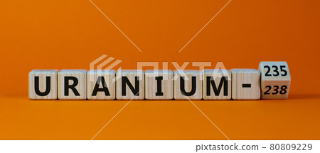 Uranium enrichment symbol. Turned the cube and changes words 'uranium-238' to 'uranium-235'. Beautiful orange background, copy space. Business, nuclear technology and uranium enrichment concept. 80809229