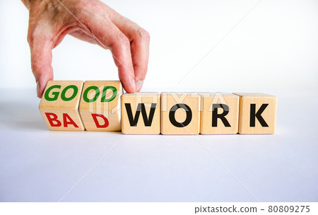 Good or bad work symbol. Businessman turns wooden cubes and changes words 'bad work' to 'good work'. Beautiful white background, copy space. Business and good or bad work concept. Good or bad work symbol. Businessman turns wooden cubes and changes words 'bad work' to 'good work'. Beautiful white background, copy space. Business and good or bad work concept. 80809275