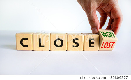 Close won or lost symbol. Businessman turns the wooden cube and changes words Close won to close lost. Beautiful white background, copy space. Business and close won or lost concept. Close won or lost symbol. Businessman turns the wooden cube and changes words Close won to close lost. Beautiful white background, copy space. Business and close won or lost concept. 80809277