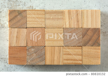 Top view - 15 small wooden cubes arranged to 3 x 5 grid, on concrete board. Letters can be added. 80810132