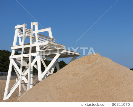 White lifeguard stand with sand pile in front and blue sky above White lifeguard stand with sand pile in front and blue sky above 80811070