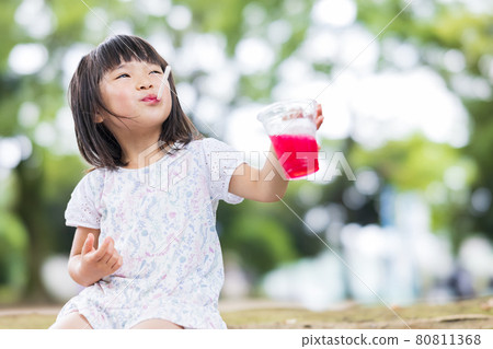 Cute girl eating shaved ice Cute girl eating shaved ice 80811368
