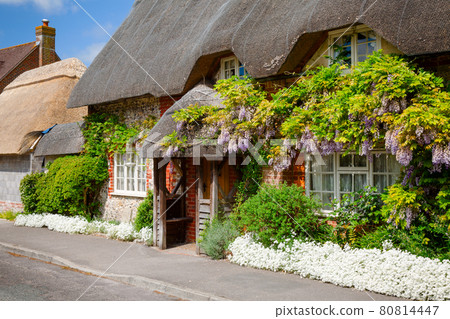 Traditional english thatched house with flower decoration in Southern England UK Traditional english thatched house with flower decoration in Southern England UK 80814447