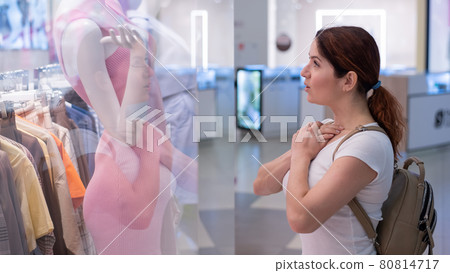 Caucasian woman looking at a shop window and dreaming about a dress. Caucasian woman looking at a shop window and dreaming about a dress. 80814717
