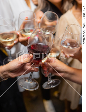Celebration. People holding glasses of white wine making a toast. 80814746