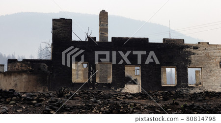 Fire Debris of Houses in a small town with smoke in sky. 80814798