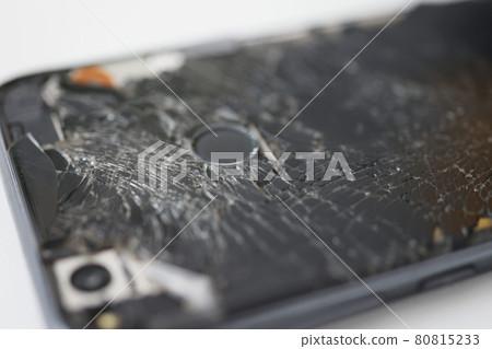 Badly broken black smartphone on white background Badly broken black smartphone on white background 80815233