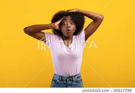 No Way. Portrait of very surprised black lady looking at camera and grabbing her head, standing over yellow background No Way. Portrait of very surprised black lady looking at camera and grabbing her head, standing over yellow background 80817296