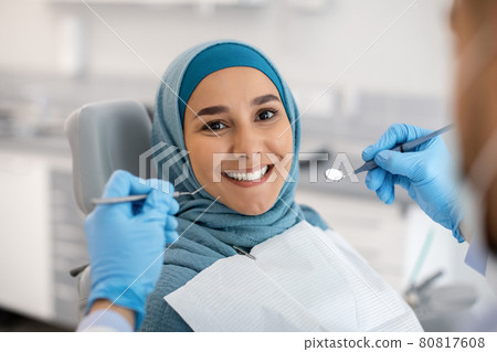 Happy Muslim Woman Sitting At Dentist Chair And Smiling At Camera 80817608