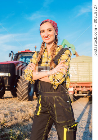 Proud famer standing in front of agricultural machinery Proud famer standing in front of agricultural machinery 80818527