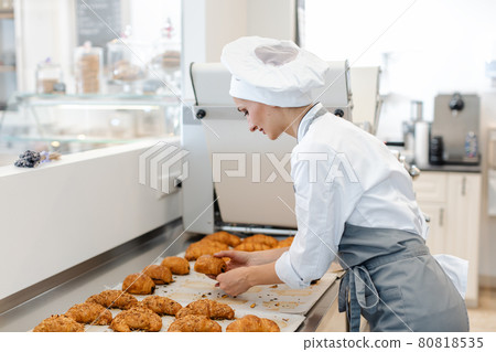 Confectioner woman baking pastry roles and chocolate bread 80818535